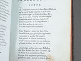 an open book with a picture of a cat sitting on top of it