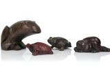 three bronze figurines of bears and a bear and a bear cub