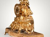 an image of a gold statue of a woman with a basket of flowers