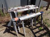 two wooden benches sitting next to each other on the ground