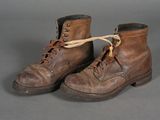 pair of brown leather boots with brown laces on a gray background