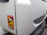 a white truck with a sticker on the side of it