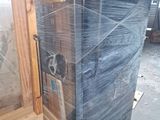 a refrigerator that is wrapped in plastic and sitting in a warehouse