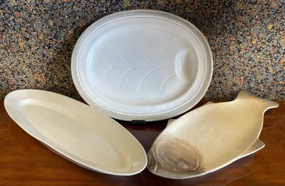 three plates and a bowl sitting on a table