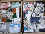 two boxes filled with assorted items sitting on a table