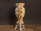 a vase that is sitting on a table with a black background