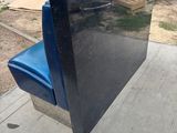 a blue toilet sitting on a concrete slab outside