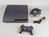 a video game console with a game controller next to it