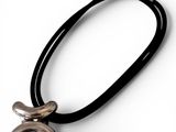 a close up of a necklace on a white surface