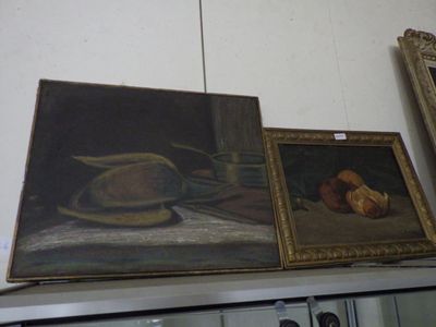 three paintings on a shelf with a hat and a loaf of bread