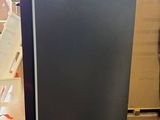 an image of a black refrigerator in a warehouse