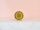 a gold coin sitting on top of a marble slab
