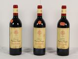 trois bouteilles de vin rouge sont alignées sur une table