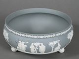 a blue bowl with white designs on it on a gray surface