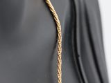 a close up of a mannequin torso with a gold chain