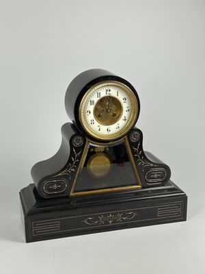 une horloge noire et or posée sur une table