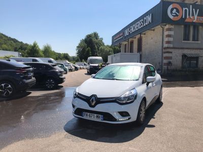 a white car parked in front of a building in a parking lot