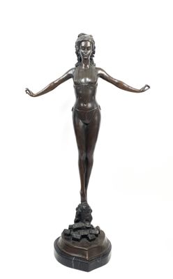 bronze statue of a woman standing on a pedestal with her arms outstretched