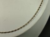 a close up of a gold chain on a mannequin