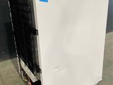 a white refrigerator with a blue sticker on it
