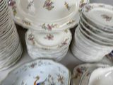 a lot of plates and bowls on the table