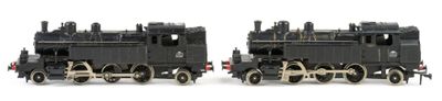 two toy trains sitting side by side on a white surface
