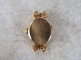 an image of a close up of a gold ring on a marble surface