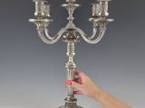 a silver candelab with five candles on it