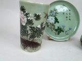 two vases and a plate sitting on a table