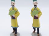 two figurines of a man and a woman holding books