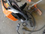 a chainsaw with a cord attached to it sitting on the ground