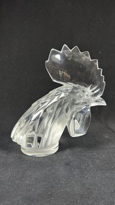 clear glass rooster figurine on a black background