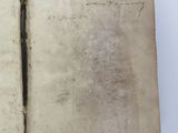 an old book with writing on it sitting on top of a table