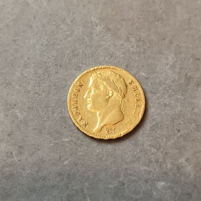 gros plan d'une pièce d'or sur une surface grise