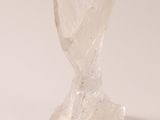 a glass sculpture of a flower on a white surface