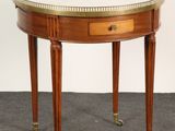 a small round table with a marble top and two legs