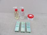 a bottle of lotion, a bottle of lotion, and two bottles of lotion sitting on a table