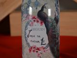 a bottle with a picture of a peacock on it