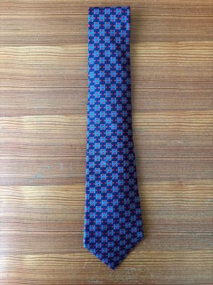 a blue and black tie on a wooden table