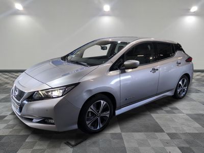 a silver nissan leaf electric car parked on a checkered floor