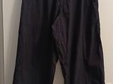 navy blue pants hanging on a white door in a room