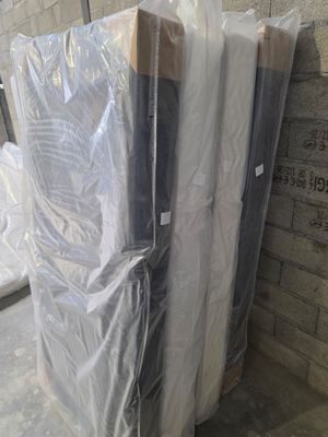 a stack of mattresses sitting on a pallet in a warehouse