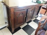 une armoire dans un coin d'une pièce dont le sol est en damier noir et blanc