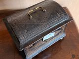 a small metal box sitting on a wooden table