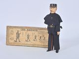 a figurine of a man in uniform standing next to a box