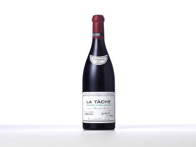 a bottle of red wine sitting on top of a table