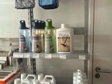 many bottles of cleaning products on the shelves in the kitchen