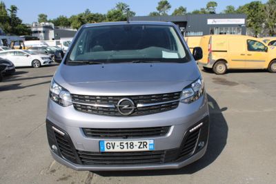 vue de face d'une camionnette argentée garée sur un parking