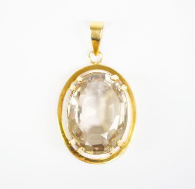 a gold plated pendant with a faceted white topaz stone