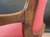 a wooden chair with a pink seat and a pink cushion